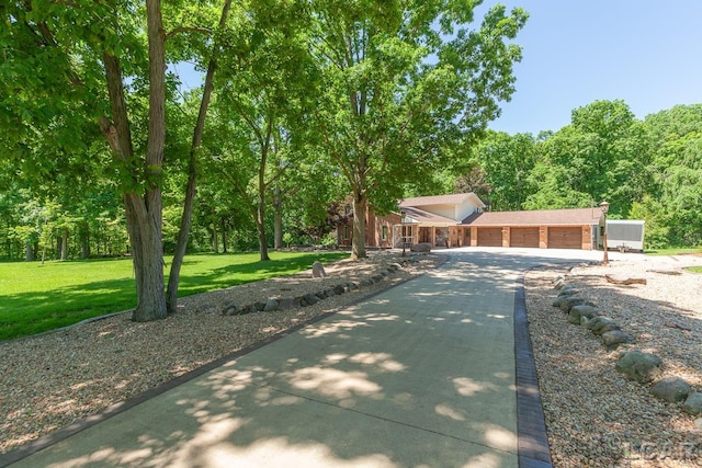 view of front of home with a front lawn and a garage