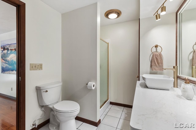 bathroom featuring tile patterned floors, sink, an enclosed shower, and toilet