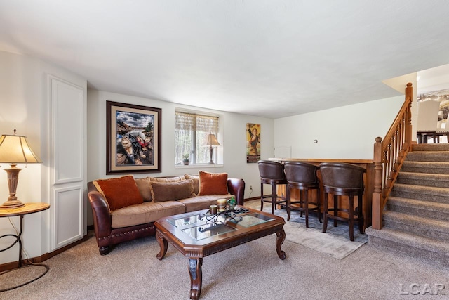 carpeted living room featuring bar area