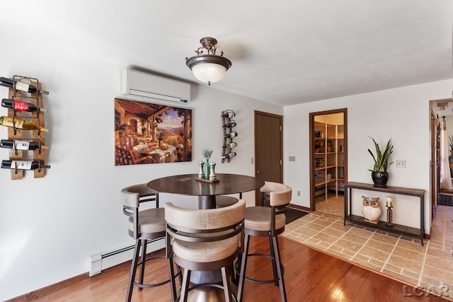 dining space with a wall unit AC, a baseboard radiator, and hardwood / wood-style flooring