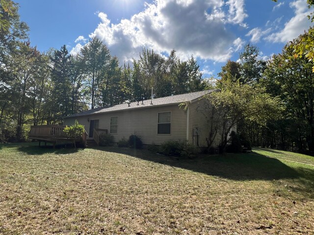 9996 N Chippewa Rd, Coleman, MI 48618 - back of property with a deck and a lawn