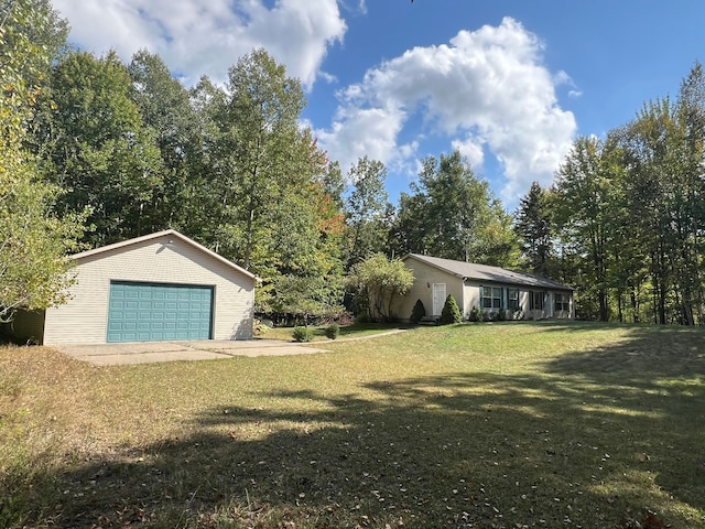 view of front of house featuring a garage, an outdoor structure, and a front yard