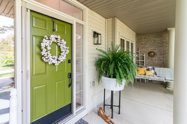 view of exterior entry with covered porch