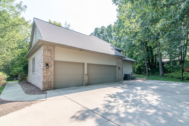 view of property exterior featuring cooling unit and a garage