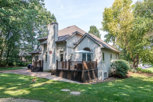 view of front facade with a front lawn and a wooden deck