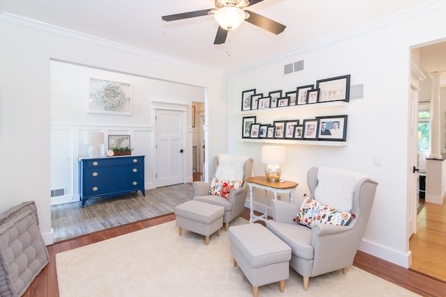 sitting room featuring crown molding and wood-type flooring