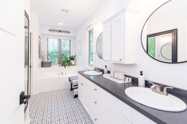 bathroom with a bath and vanity