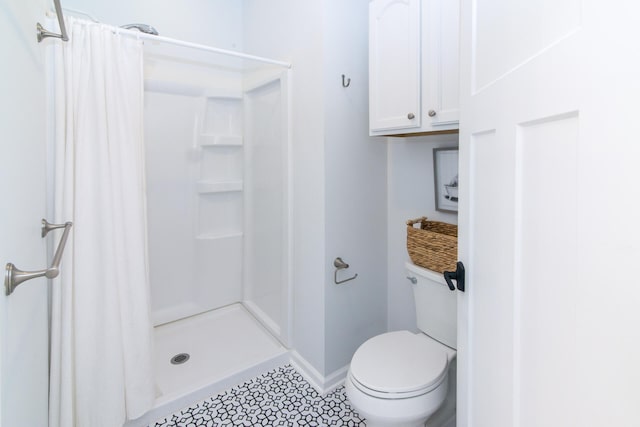 bathroom with a shower with curtain and toilet