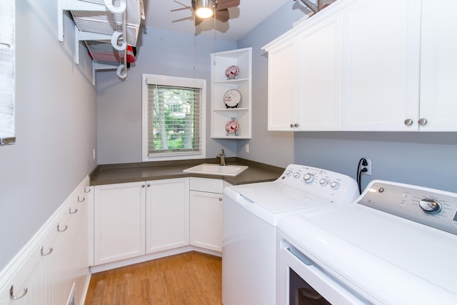 laundry room featuring washer and clothes dryer, cabinets, sink, ceiling fan, and light wood-type flooring