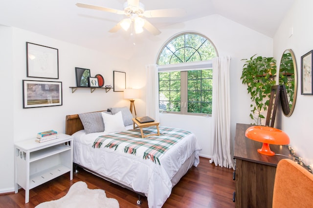 bedroom featuring ceiling fan, dark wood-type flooring, and vaulted ceiling