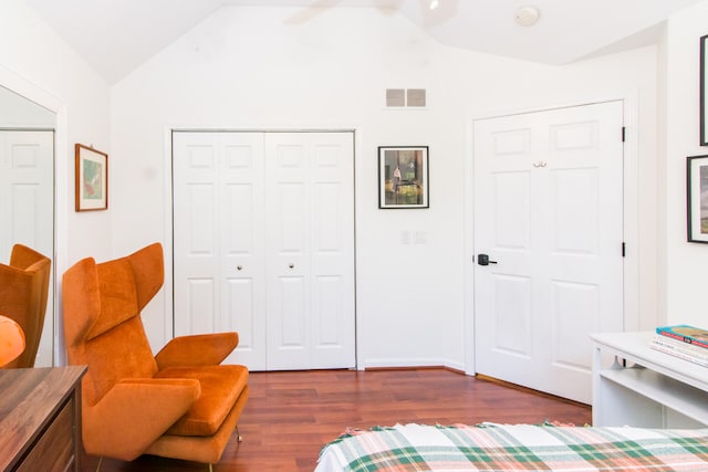 living area with vaulted ceiling and dark wood-type flooring