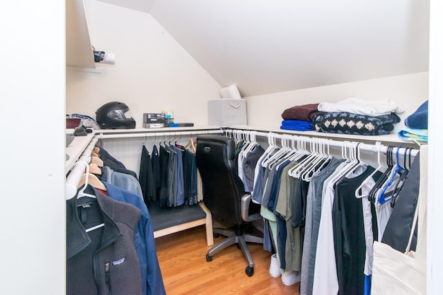 walk in closet featuring hardwood / wood-style flooring and lofted ceiling