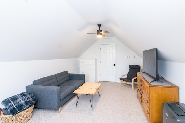 sitting room featuring ceiling fan, light colored carpet, and lofted ceiling