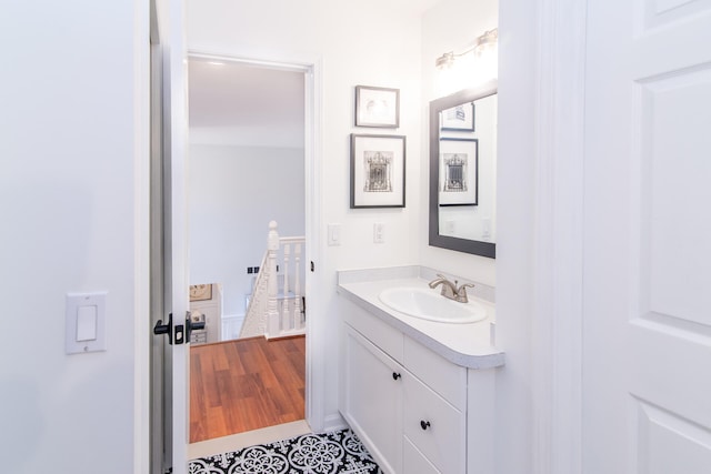 bathroom with vanity and hardwood / wood-style flooring