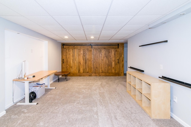 basement with a drop ceiling and light colored carpet