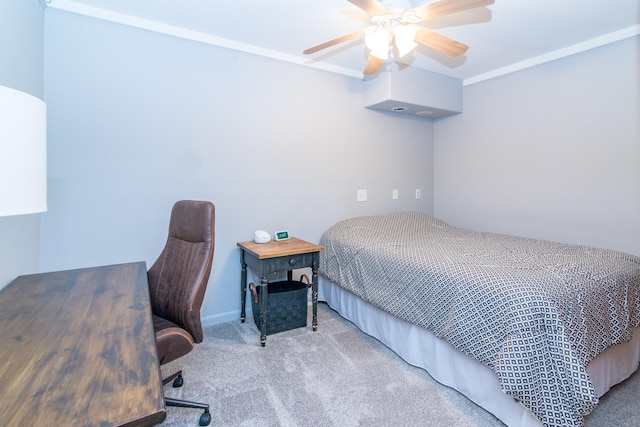 carpeted bedroom featuring ceiling fan and crown molding