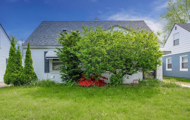 view of property exterior with a yard and roof with shingles