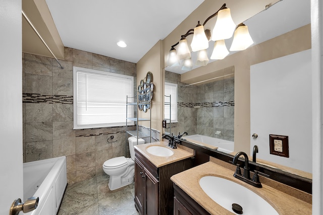 bathroom featuring a tub, vanity, tile walls, and toilet