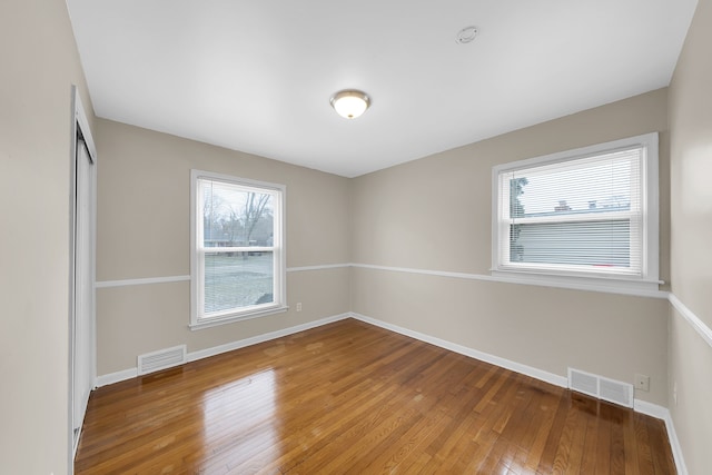 empty room with hardwood / wood-style floors