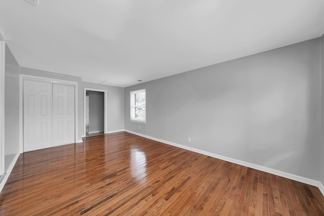 unfurnished bedroom featuring a closet and hardwood / wood-style floors