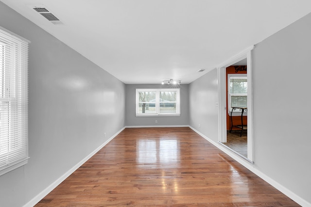 unfurnished room featuring hardwood / wood-style flooring