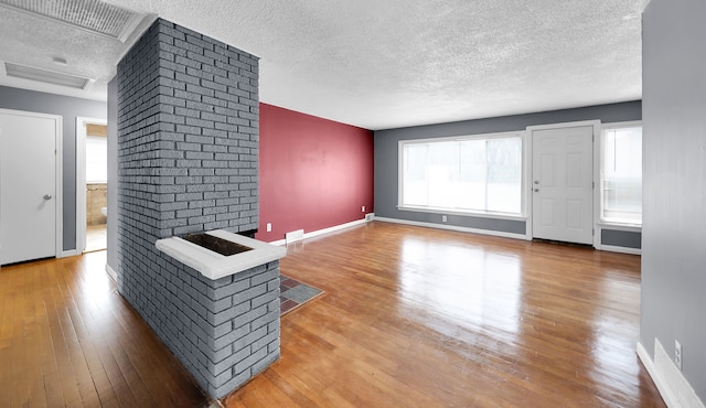 living room with hardwood / wood-style floors and a textured ceiling