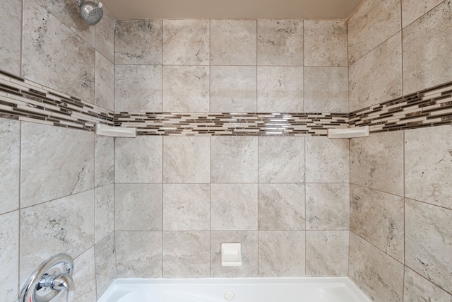 interior space featuring tiled shower / bath combo