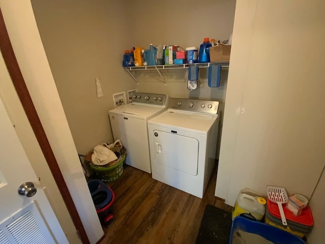 laundry area featuring dark hardwood / wood-style flooring and washing machine and clothes dryer