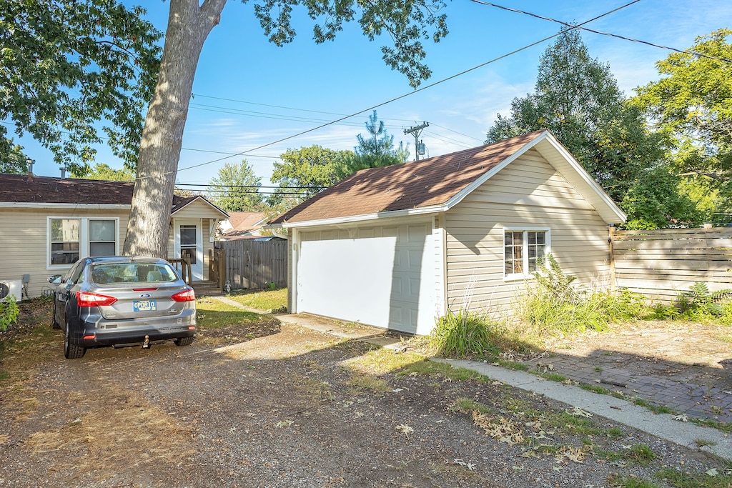 view of home's exterior with an outdoor structure and a garage