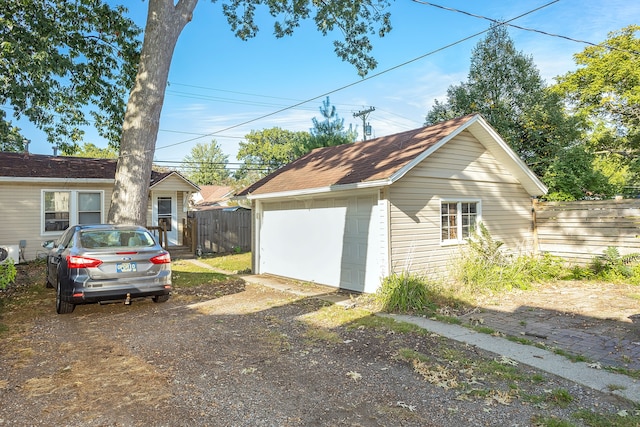 view of home's exterior with an outdoor structure and a garage