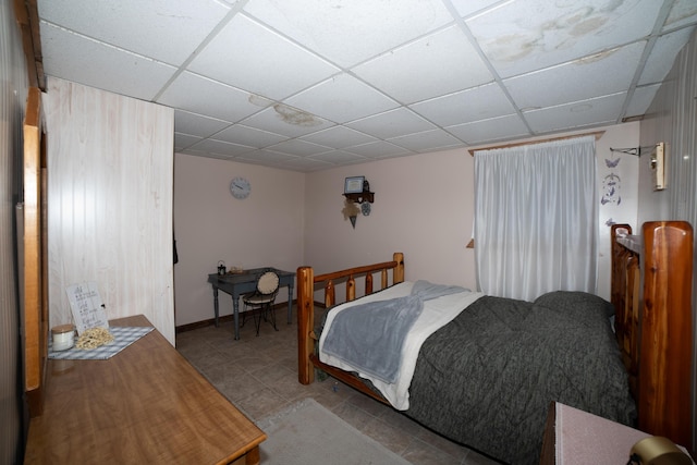21493 20 Mile Rd, Tustin, MI 49688 - bedroom featuring a drop ceiling and tile patterned floors