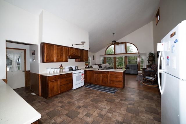 21493 20 Mile Rd, Tustin, MI 49688 - kitchen with white appliances, high vaulted ceiling, a peninsula, a ceiling fan, and light countertops