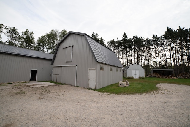 21493 20 Mile Rd, Tustin, MI 49688 - view of barn with gravel driveway and a lawn