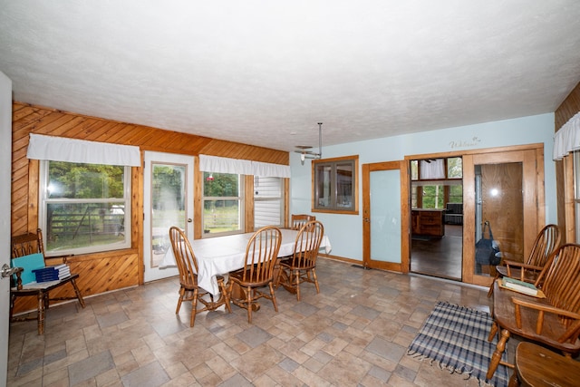 21493 20 Mile Rd, Tustin, MI 49688 - dining space with stone tile floors and wooden walls