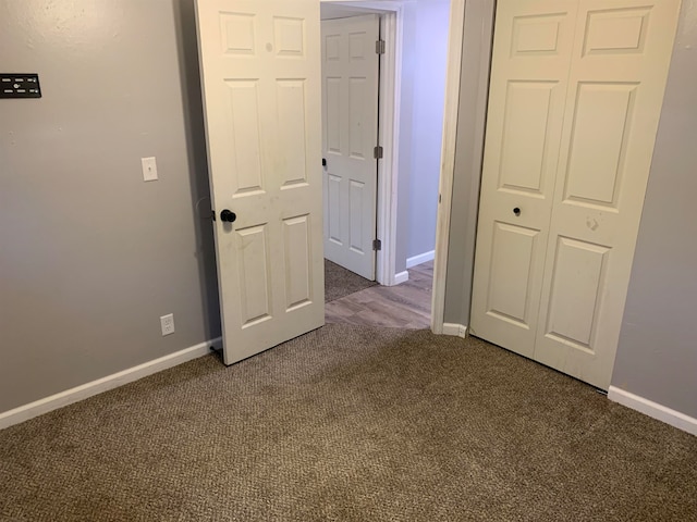 unfurnished bedroom with a closet and carpet