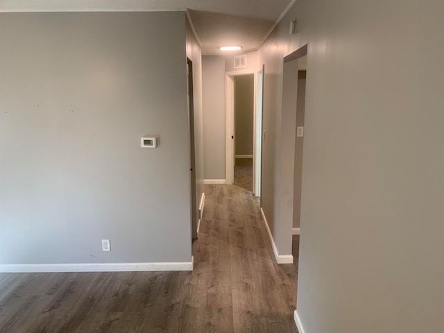 corridor with dark hardwood / wood-style flooring