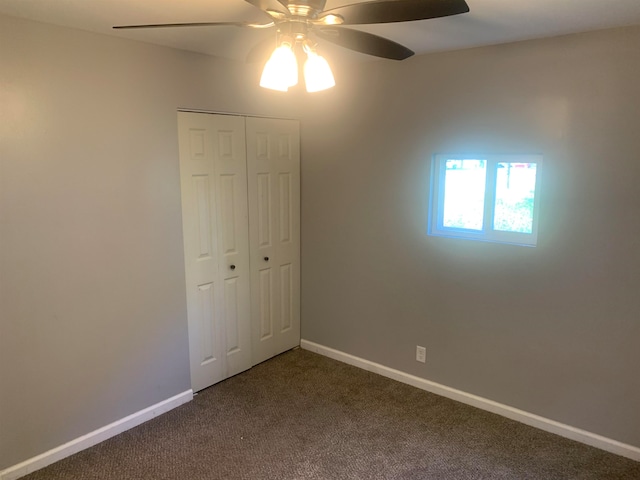 unfurnished bedroom with carpet, a closet, and ceiling fan