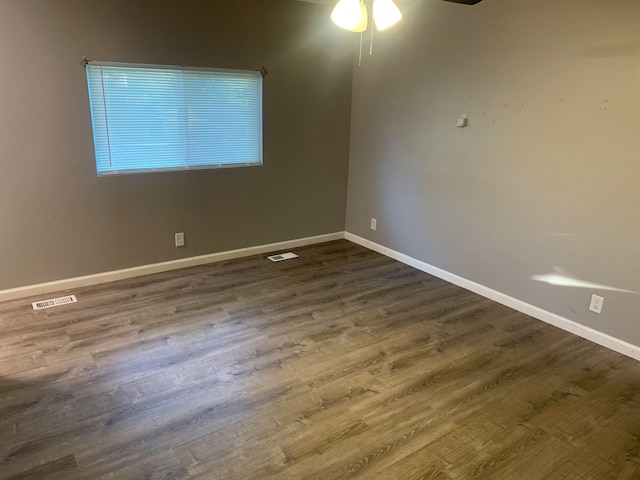 spare room featuring ceiling fan and dark hardwood / wood-style flooring