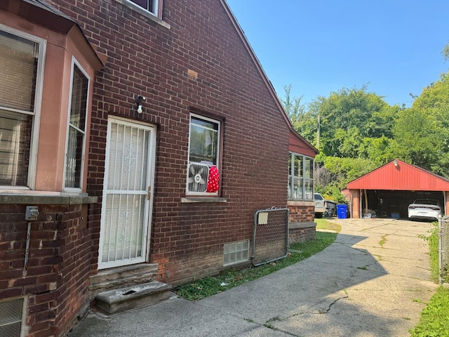 view of side of home featuring an outbuilding, a garage, and a carport