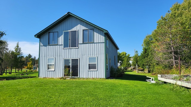 rear view of house featuring a yard