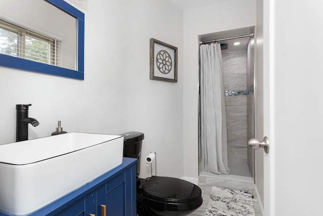 bathroom featuring vanity, toilet, and walk in shower