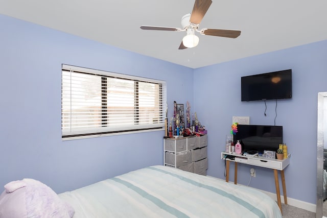 bedroom featuring ceiling fan and carpet