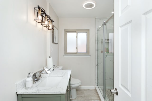 bathroom with walk in shower, vanity, and toilet