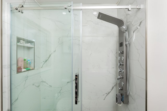 bathroom with a shower with shower door