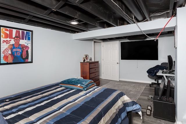 bedroom with dark hardwood / wood-style floors