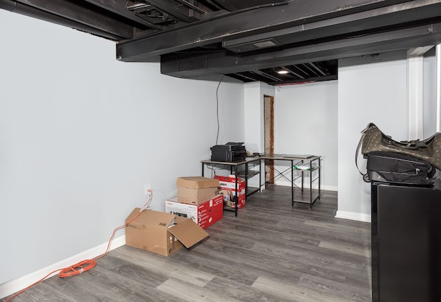 basement with hardwood / wood-style flooring