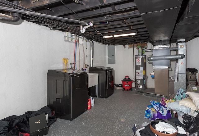 basement featuring heating unit, washing machine and clothes dryer, electric panel, and water heater