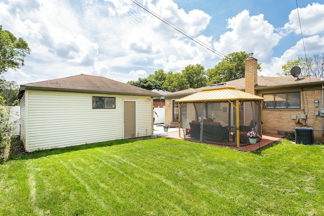 rear view of house featuring outdoor lounge area, a gazebo, central AC unit, a patio area, and a yard