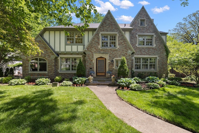 tudor house featuring a front lawn