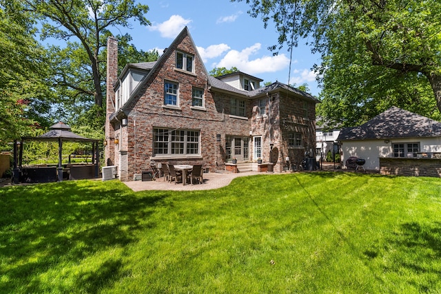 back of property with a gazebo, central AC unit, a patio, and a lawn